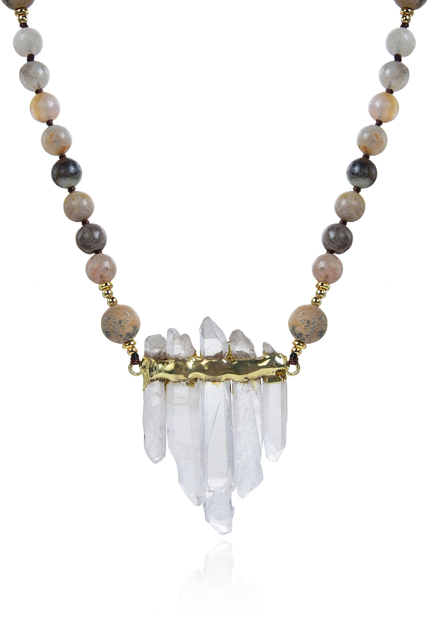 Close up view of pendant on grey agate beaded necklace. Pendant is composed of 5 quartz crystals in pyramid arrangement with gold band wrapped along top. Agate beads made of a variety of grey and brown colors compose the chain.
