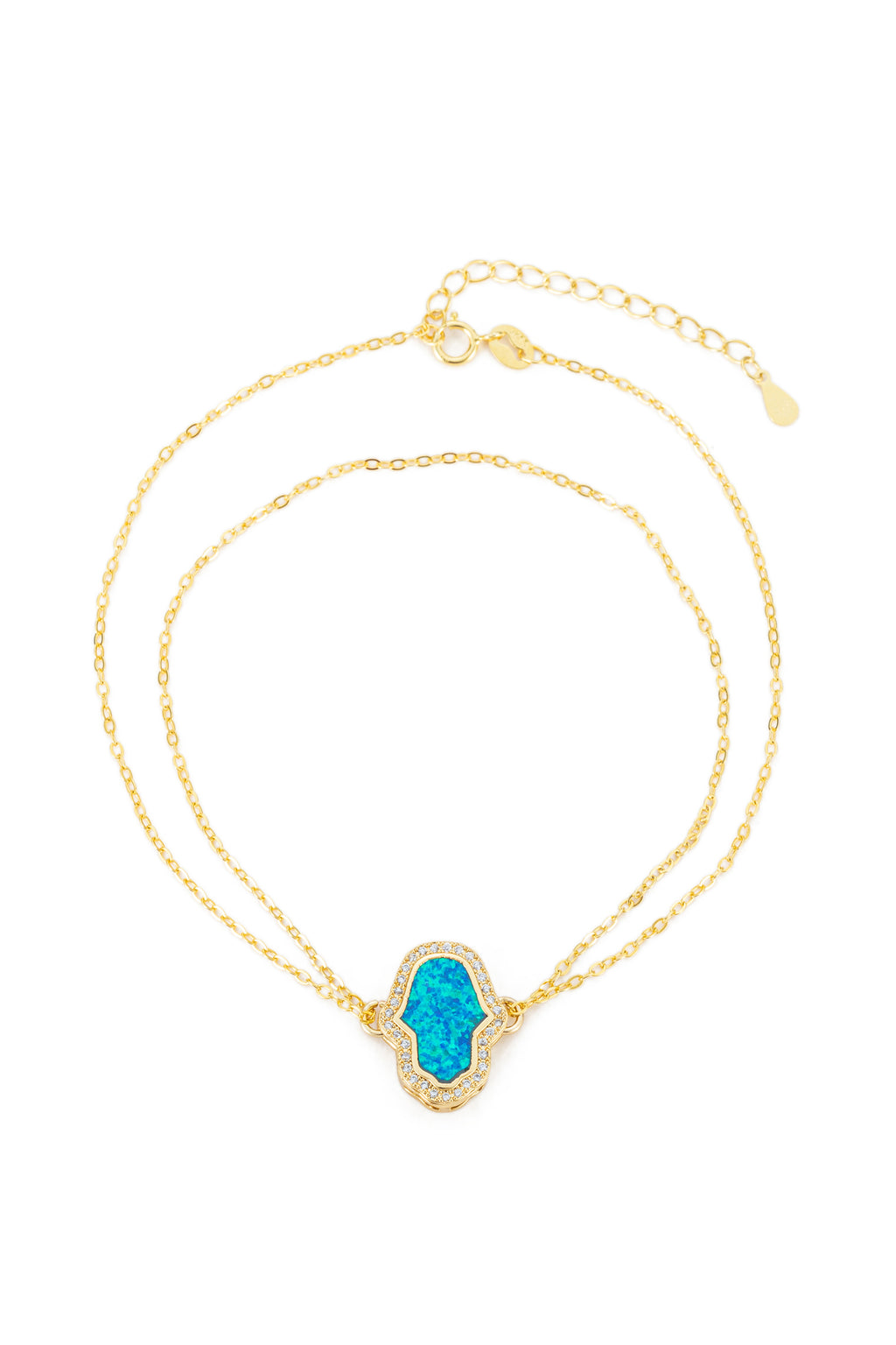 14k gold plated sterling silver hamsa hand bracelet studded with CZ crystals and a blue opal charm.