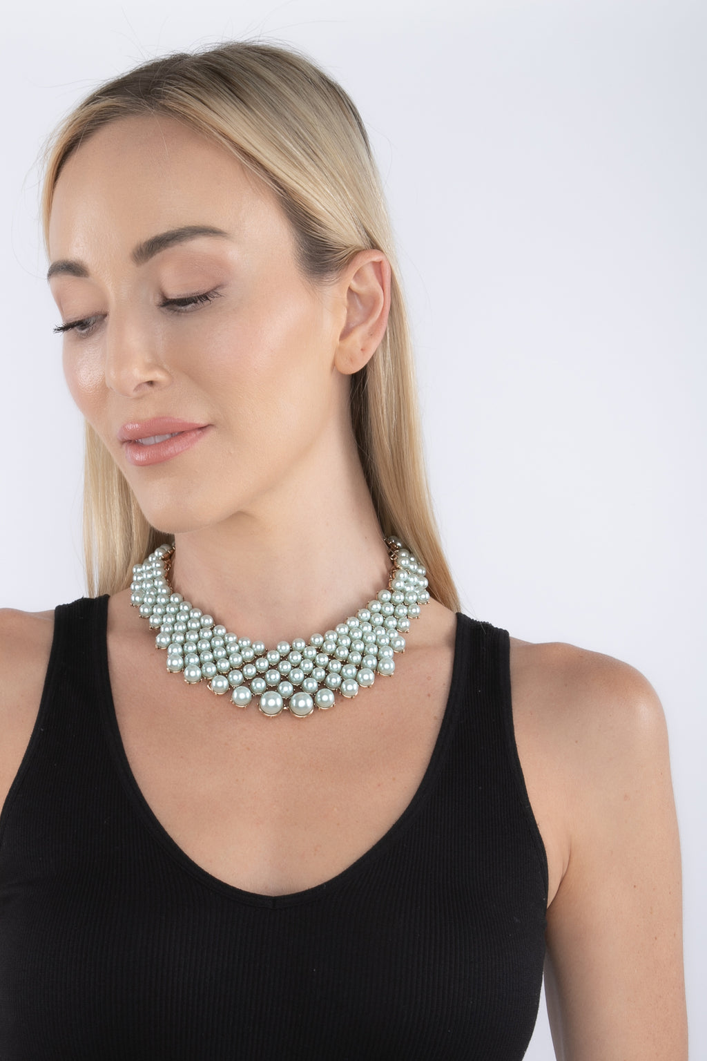 Teal alloy statement necklace studded with glass crystals.