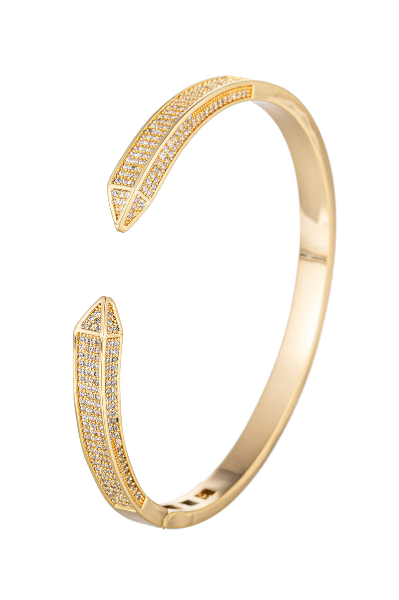 Gold tone titanium spike cuff bracelet studded with CZ crystals.