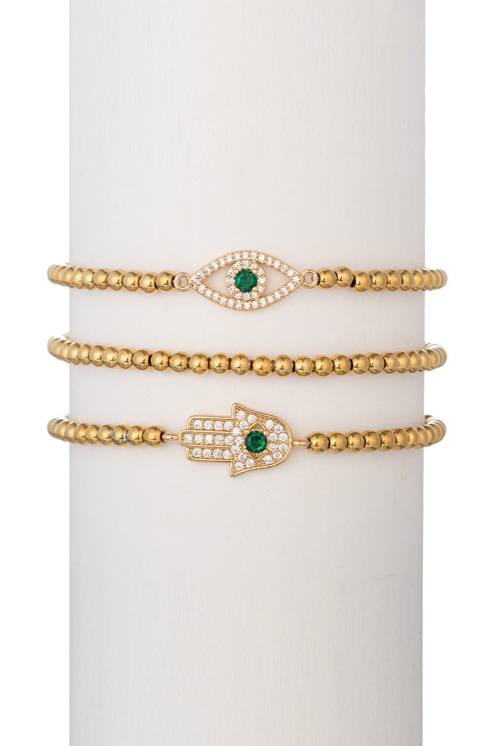 Gold tone brass eye and hamsa pendant bracelet set studded with CZ crystals.