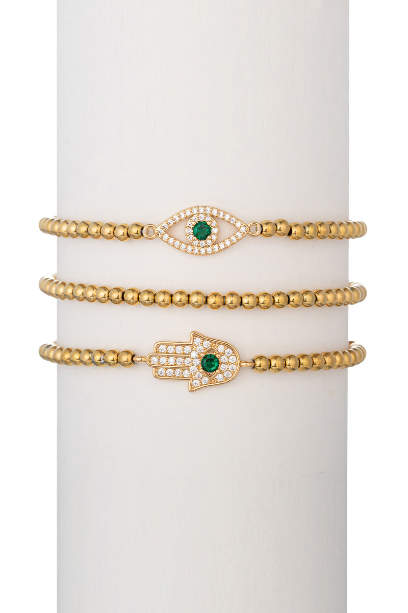 Gold tone brass eye and hamsa pendant bracelet set studded with CZ crystals.