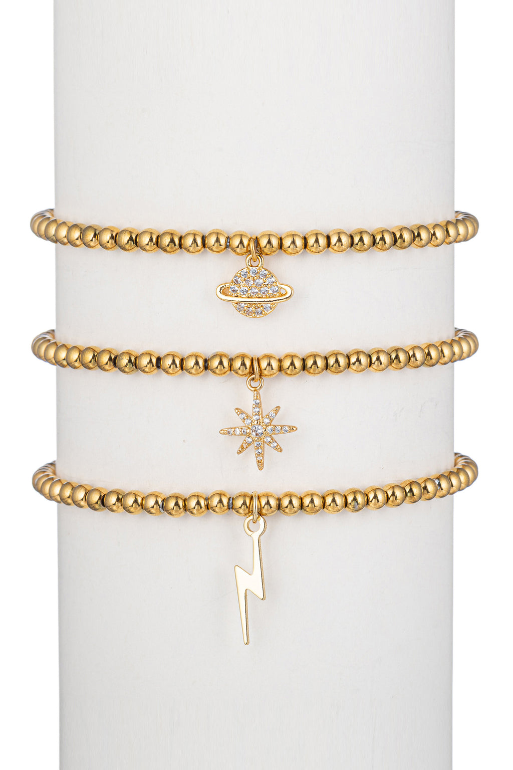 Saturn, star and lightning bolt pendant bracelet set studded with CZ crystals.