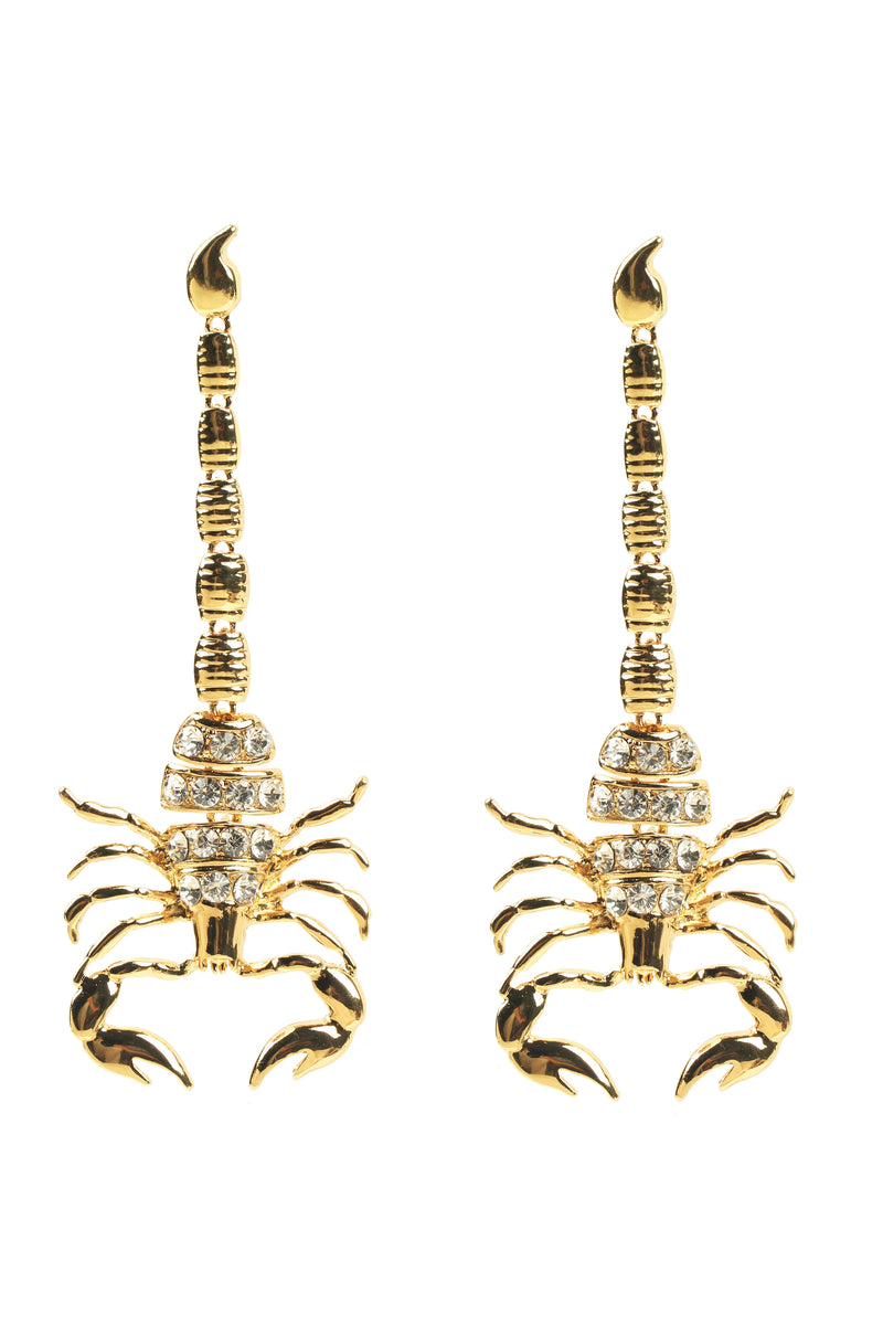 Gold scorpion pendant earrings studded with glass crystals.