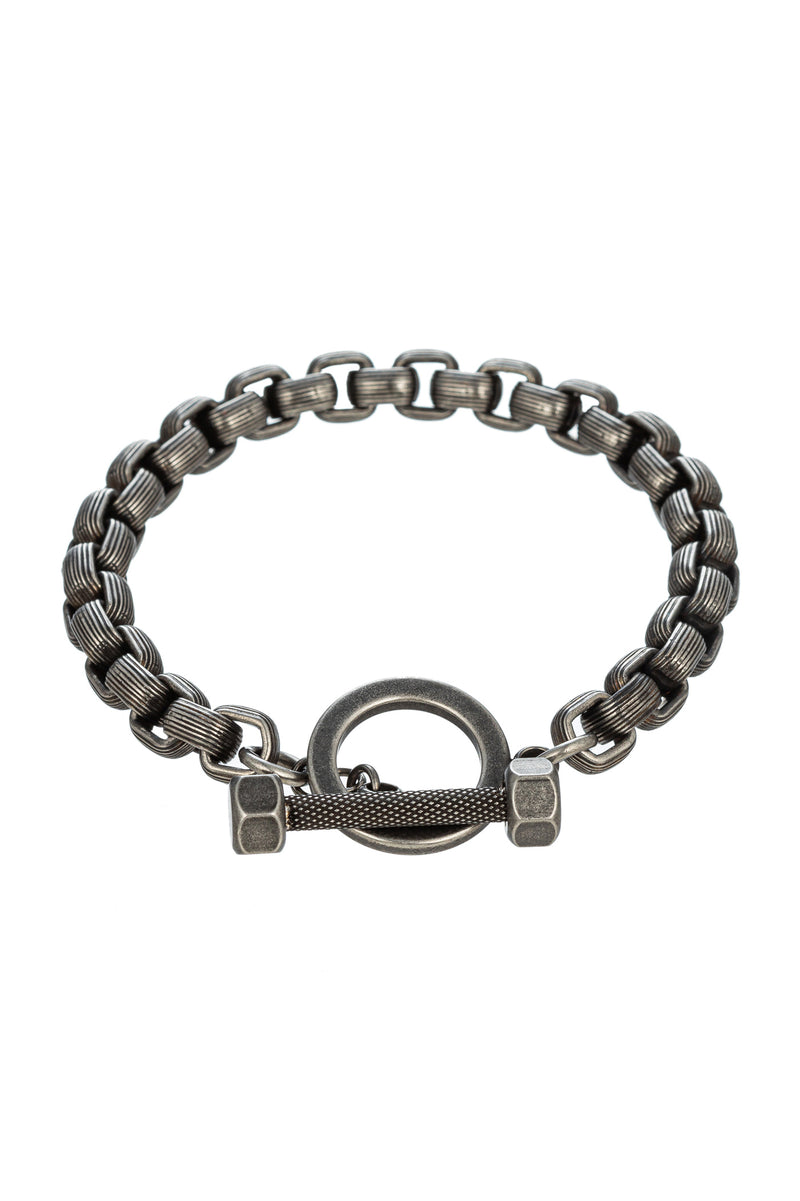Silver tone titanium chain link bracelet with a ring pendant.