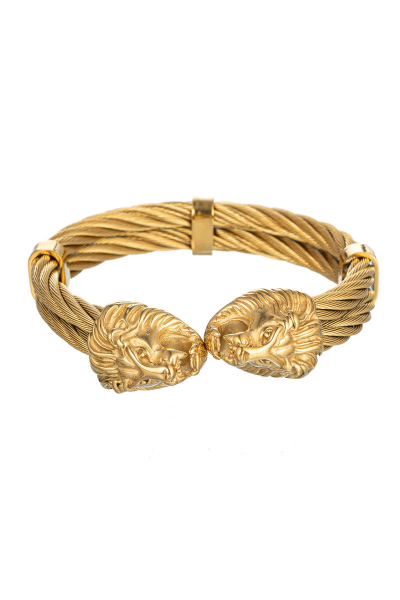 Gold tone titanium double lion head cuff bracelet.