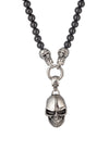 Silver tone titanium skull pendant on a beaded necklace.
