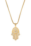 Gold tone titanium hamsa hand pendant studded with CZ crystals.
