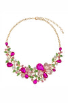Gold tone alloy flower statement necklace with hot pink glass crystals.