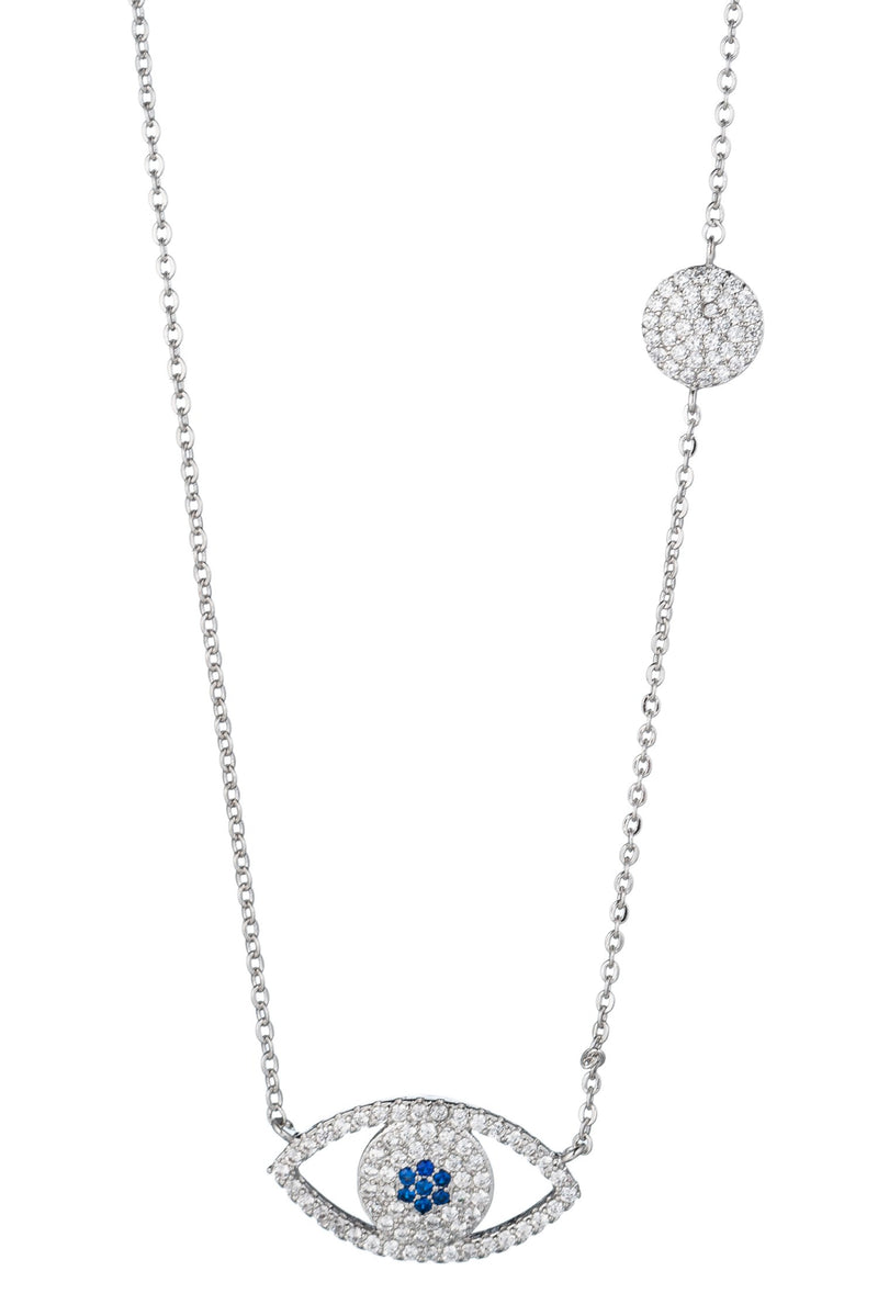 Small silver necklace with thin chain featuring silhouette evil eye pendant with blue iris. Pendant studded with shining cubic zirconia crystals. Small circle charm with cubic zirconia studs also on neckline.