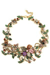 A floral garland collar necklace with crystal faceted pink flowers and green leaves