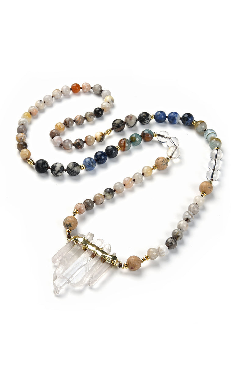 Complete view of 16 inch necklace with round agate beads of various colors and pendant composed of 5 white quartz crystals.