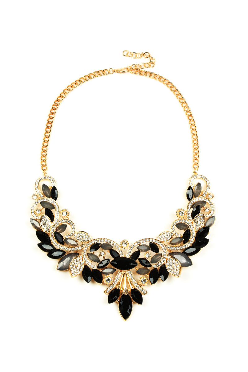 Gold tone alloy golden wing necklace with black glass crystals.