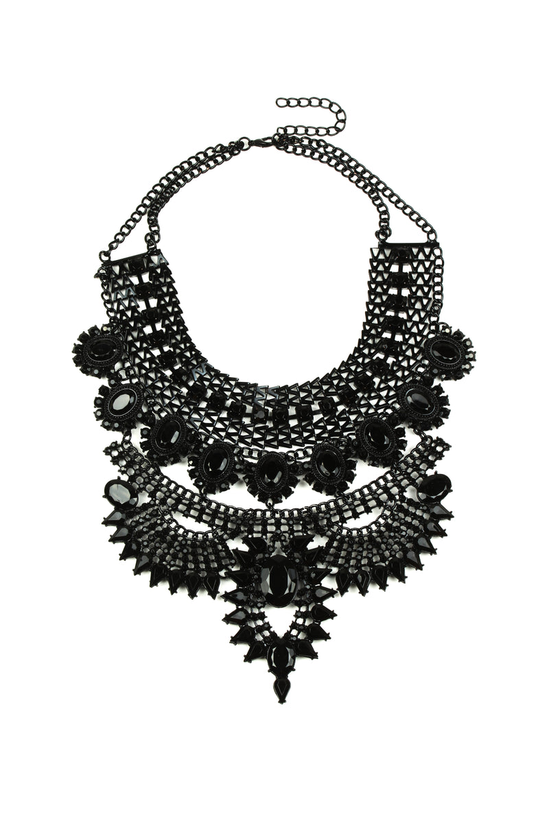 Black alloy tribal statement necklace studded with glass crystals.