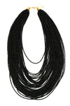 Large black statement necklace with layers of beaded chains. Beaded chains are layered to create a stacked look.