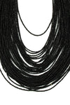 Close up view of small beaded chains composing necklace.