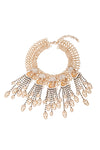 Gold tone alloy golden skull pendant necklace studded with glass crystals.