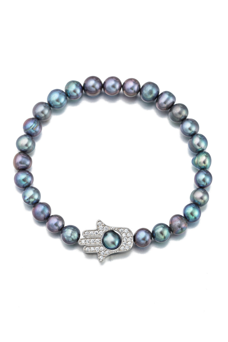 Peacock pearl bracelet with a hamsa hand pendant that is studded with CZ crystals.