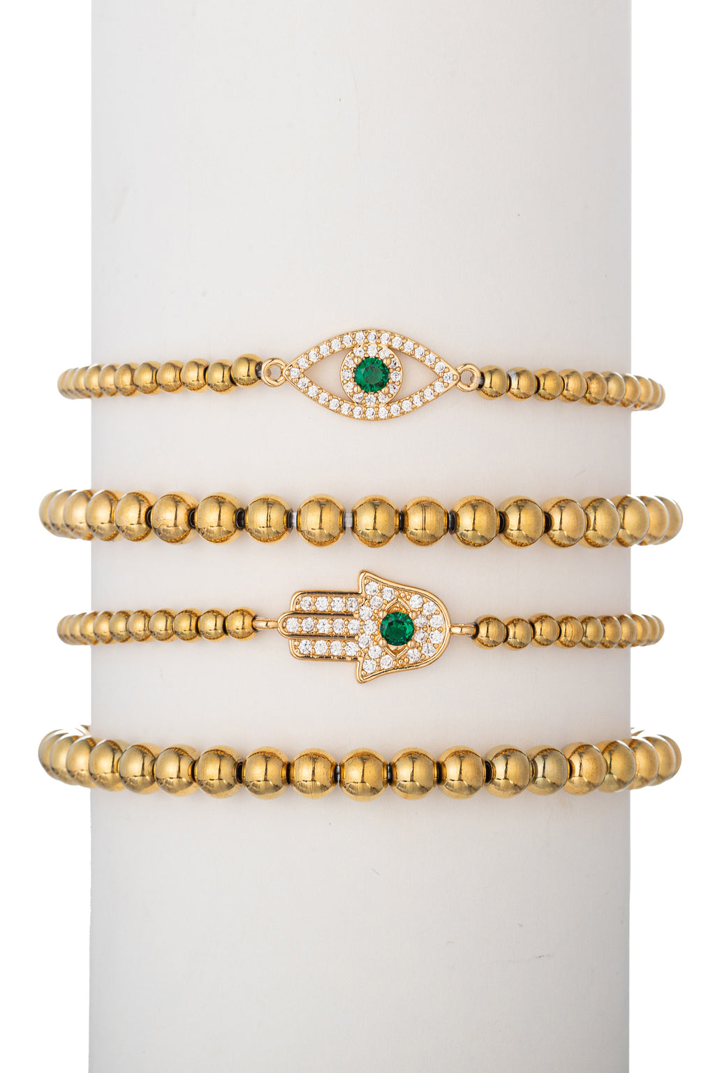 Gold tone titanium beaded bracelet set with green CZ crystal evil eye and hamsa hand pendants.