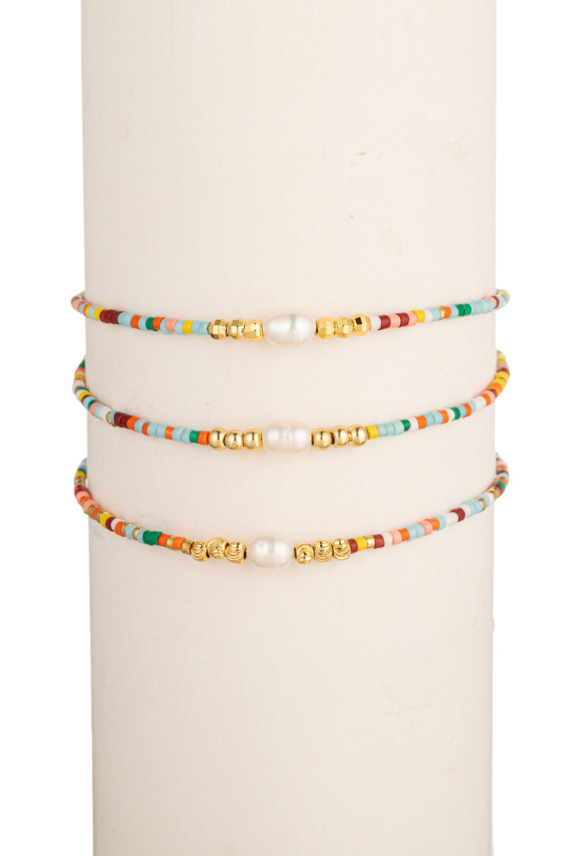Gold tone titanium bracelet set with rainbow beads and shell pearls.