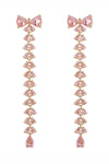 Gold tone brass bow earrings studded with pink CZ crystals.