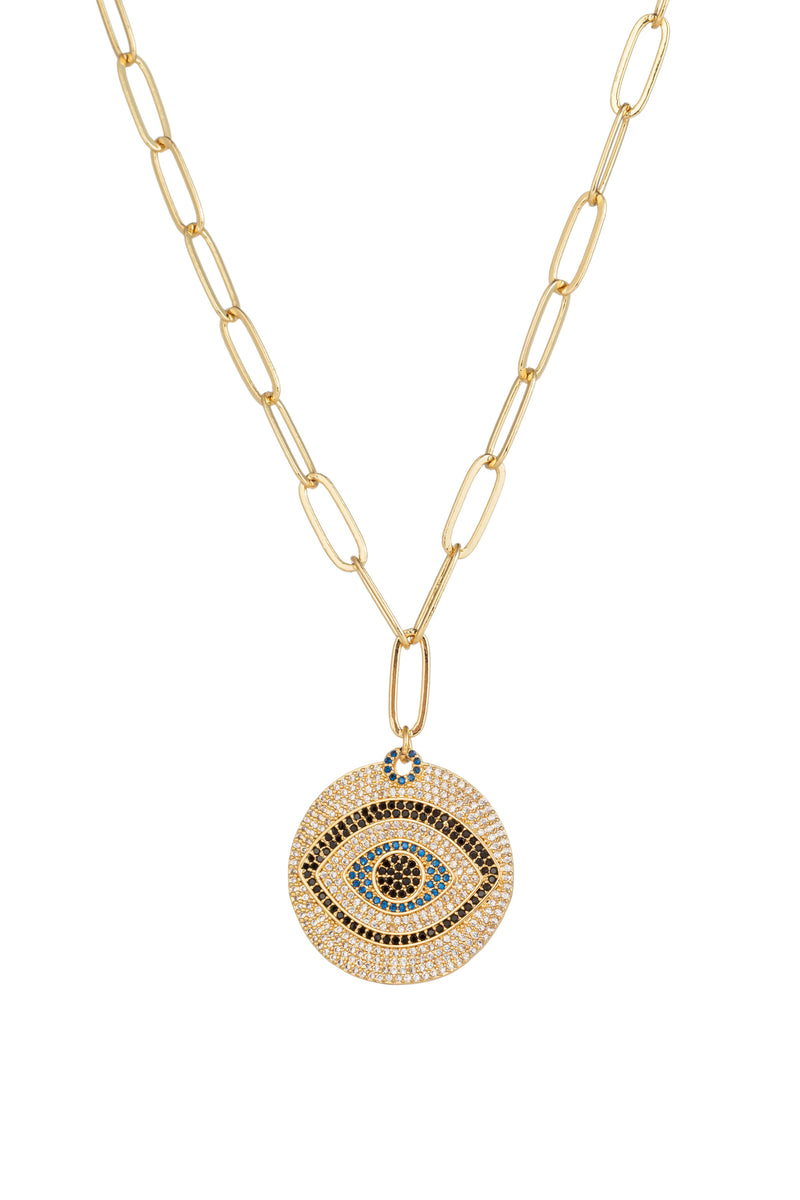 Evil eye brass pendant on a gold sterling silver chain necklace.