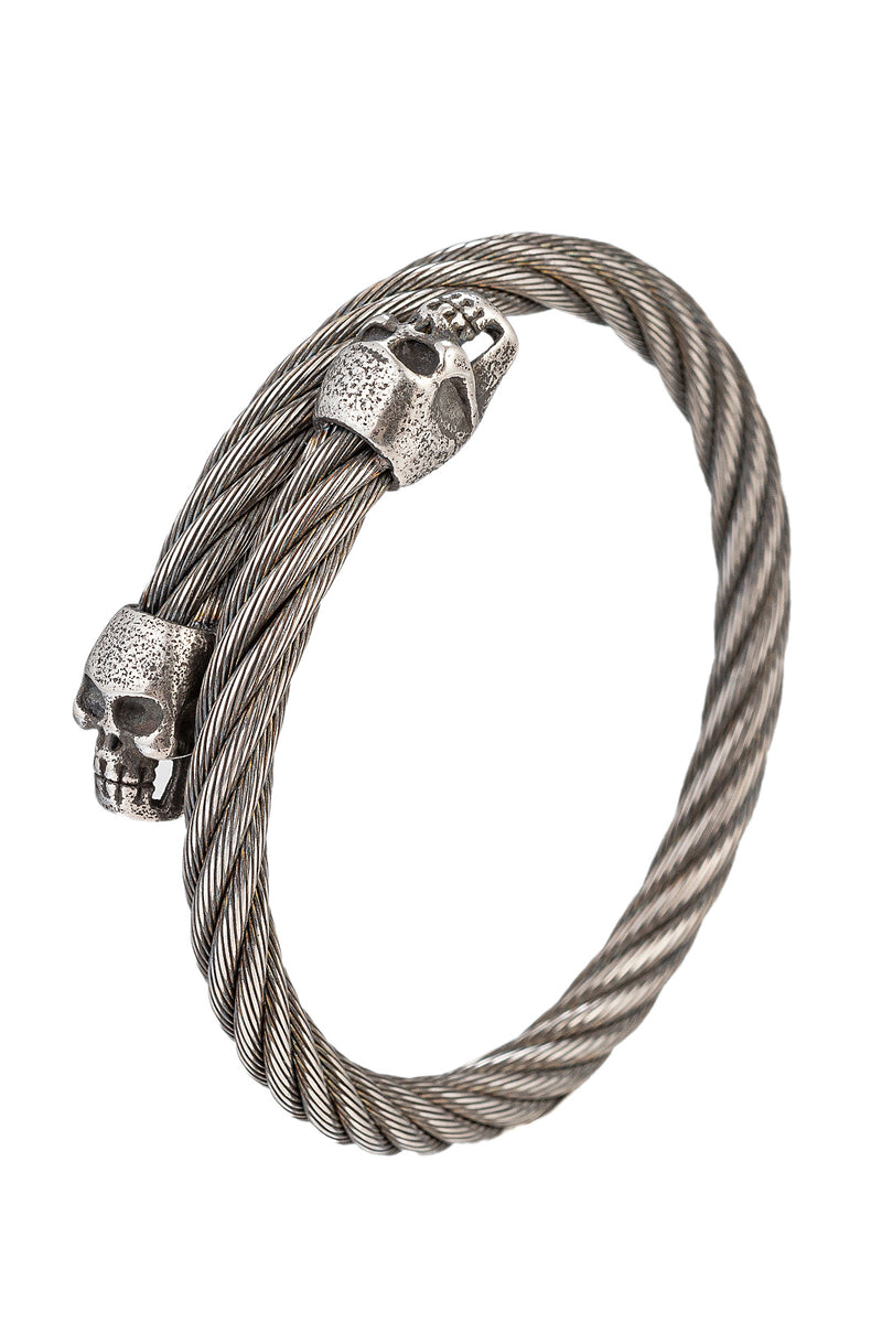 Black tone titanium double skull head coil bracelet.